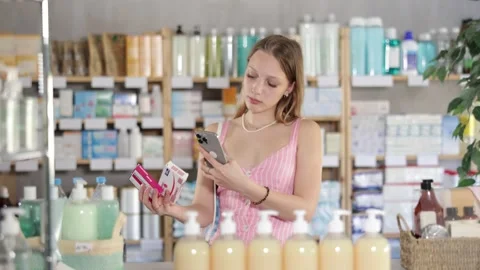 Young woman scanning qr code of paracetamol Stock Footage 322115216