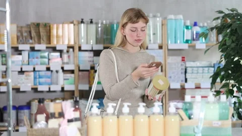 Young woman scanning qr code of baby formula Stock Footage 329394267