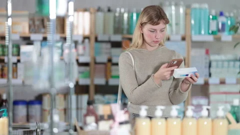 Young woman scanning qr code of ointment Stock Footage 329398085