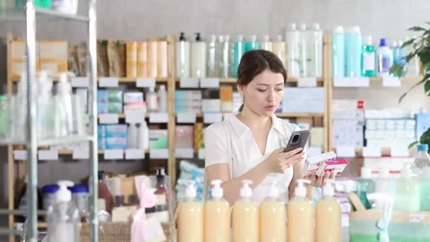 Young woman scanning qr code of paracetamol Stock Footage 330402405