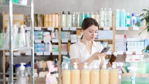 Young woman scanning qr code of syrup Stock Footage 331297730