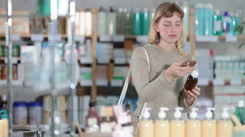Young woman scanning qr code of syrup Stock Footage 332636473