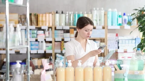 Young woman scanning qr code of cream Stock Footage 332639027
