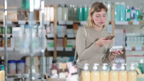 Young woman scanning qr code of paracetamol 動画素材 341427753