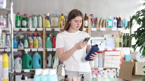 Young woman scanning qr code for cleaning spray Stock Footage 341428456