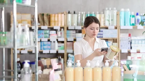 Young woman scanning qr code of baby formula 動画素材 341429691