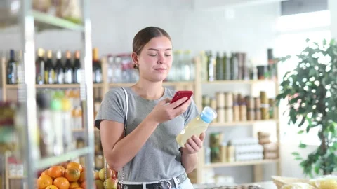 Young woman scanning qr code for mayonnaise Stock Footage 342129587