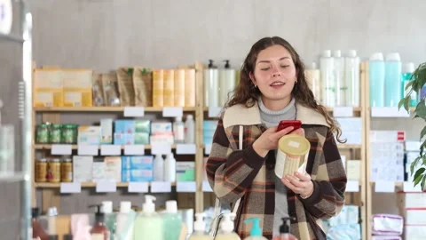 Young woman scanning qr code of baby formula Vídeo Stock 344774738