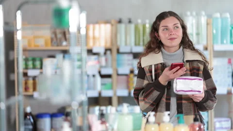 Young woman scanning qr code of feminine pads Stock-Footage 347264690