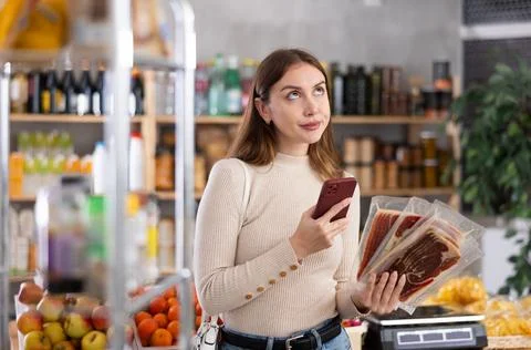 Young woman scanning qr code of jamon Foto stock