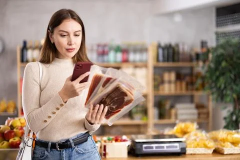 Young woman scanning qr code of jamon Foto stock