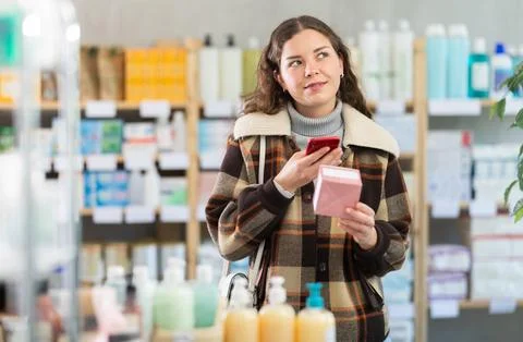 Young woman scanning qr code of pills Stock Photos