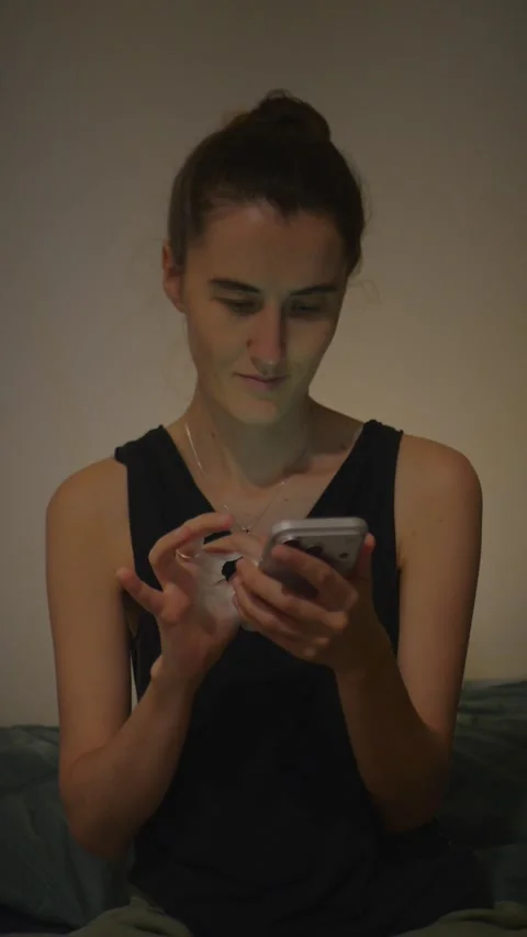 Young woman scrolling or texting on smartphone in... Video stock 337972467