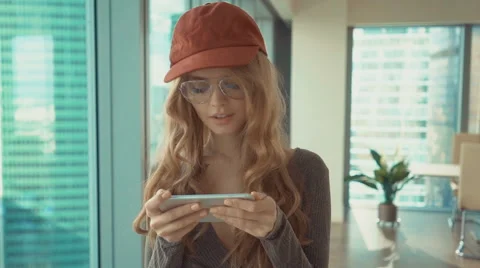 Young woman sending text message from her phone on the background of the city Stock Footage 68616695