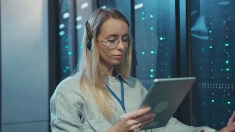 Young woman server administrator using digital tablet updating network computer Stock Footage 119233935