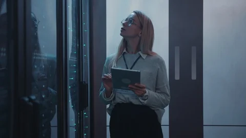 Young woman server engineer using tablet running diagnostics test with super Stock Footage 119083327
