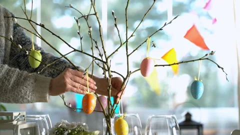 Young woman setting easter festive table with bunny and eggs decoration Stock Footage 86534384