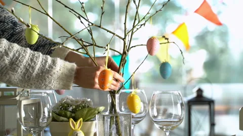 Young woman setting easter festive table with bunny and eggs decoration Stock Footage 86535575