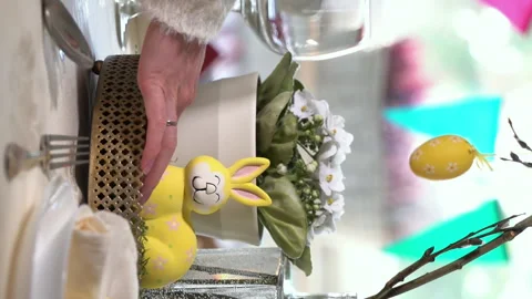 Young woman setting easter festive table with bunny and eggs decoration Stock Footage 263744258