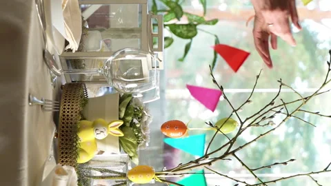 Young woman setting easter festive table with bunny and eggs decoration Stock Footage 263747707