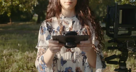 Young woman setting up large format camera in nature Stock Footage 117582374