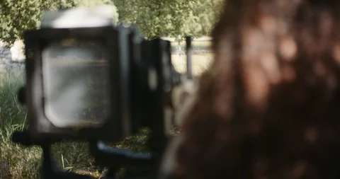 Young woman setting up large format camera in nature Stock Footage 117583123