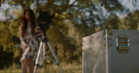 Young woman setting up large format camera in nature Stock Footage 117583138