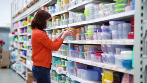 Young woman shopping in home goods department during pandemic Stock Footage