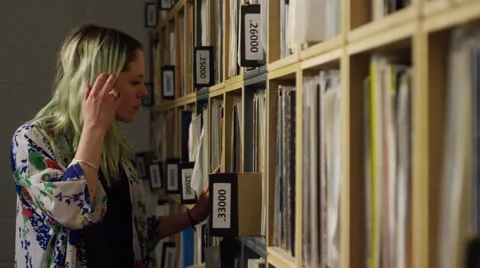 Young woman shopping for vinyl records in music store Stock Footage 59763090