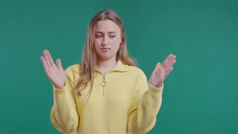 Young woman showing difference between invisible abstract subject, object sizes Stock Footage 240957700