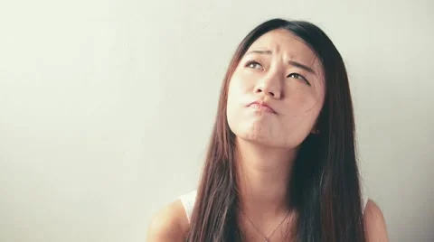 Young woman showing several expressions, isolated on white background Stock Footage