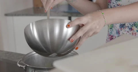 Young woman singing while cooking slow motion close up tilt up shouldershot Stock Footage 56063980