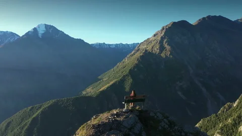 Young Woman Sitting on Bench and Looking at Amazing Mountain View. Stock Footage 143731253