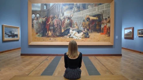Young Woman Sitting on a Bench in the Art Gallery and Looking at a Huge Picture Stock Footage