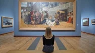 Young Woman Sitting On A Bench In The Art Gallery And Looking At A Huge Picture Stock Footage