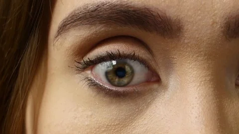 Young woman sitting in front of a computer.Reflection of running numbers in eyes Stock Footage 126091993