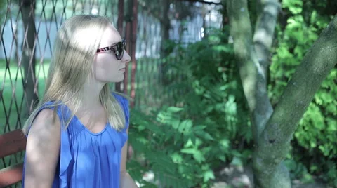 Young woman sitting outside drinking coffee  glass Stock Footage 59142820