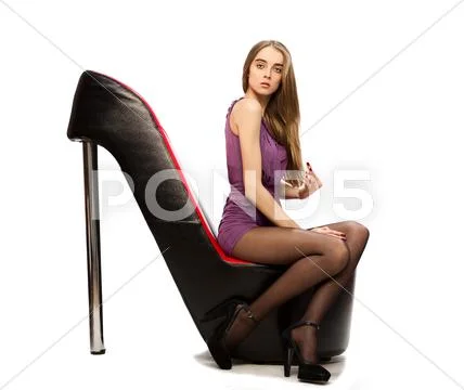 Young woman sitting on the shoes chair. Concept photo for advertisement the s Stock Photos