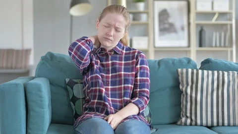 Young Woman Sitting While having neck pain Stock Footage 114788337
