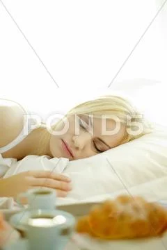 Young woman sleeping in bed Stock Photos