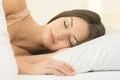 The young woman sleeping on the bed Photo