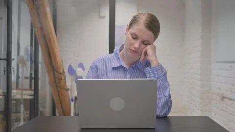 Young Woman Sleeping while Working on Laptop Stock Footage 309509745