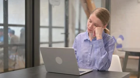 Young Woman Sleeping while Working on Laptop Stock Footage 309516071