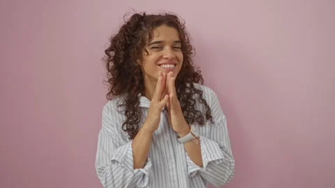 Young woman smiling and clapping over an isolated pink background, wearing .. Stock Footage 289701864