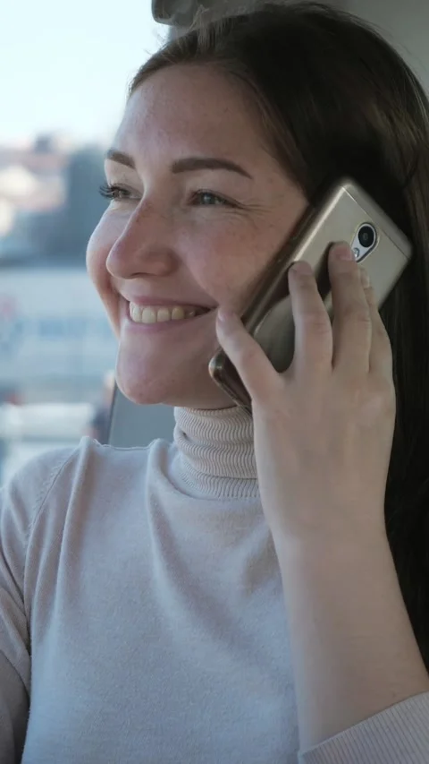 Young woman smiling and talking on smartphone while traveling Video stock 341441253