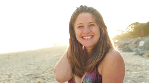 Young Woman Smiling at Camera on the Beach Stock Footage 24792321
