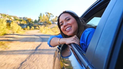 Young woman smiling with her head out window Stock Footage
