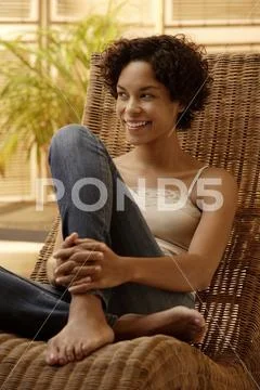 Young woman smiling holding leg. Stock Photos
