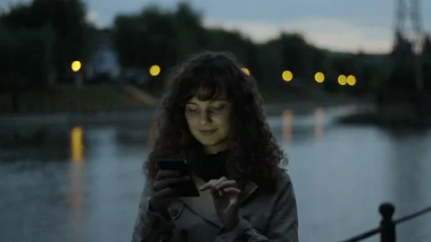 Young Woman Smiling Using Her Smartphone. Stock Footage 90176566