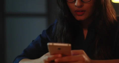 Young woman smiling while having a chat with her friends on whats app	 Stock Footage 138861025